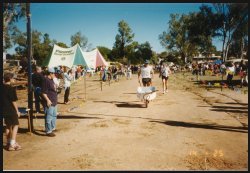 Peter crossing the finish line of the wheelbarrow derby.
